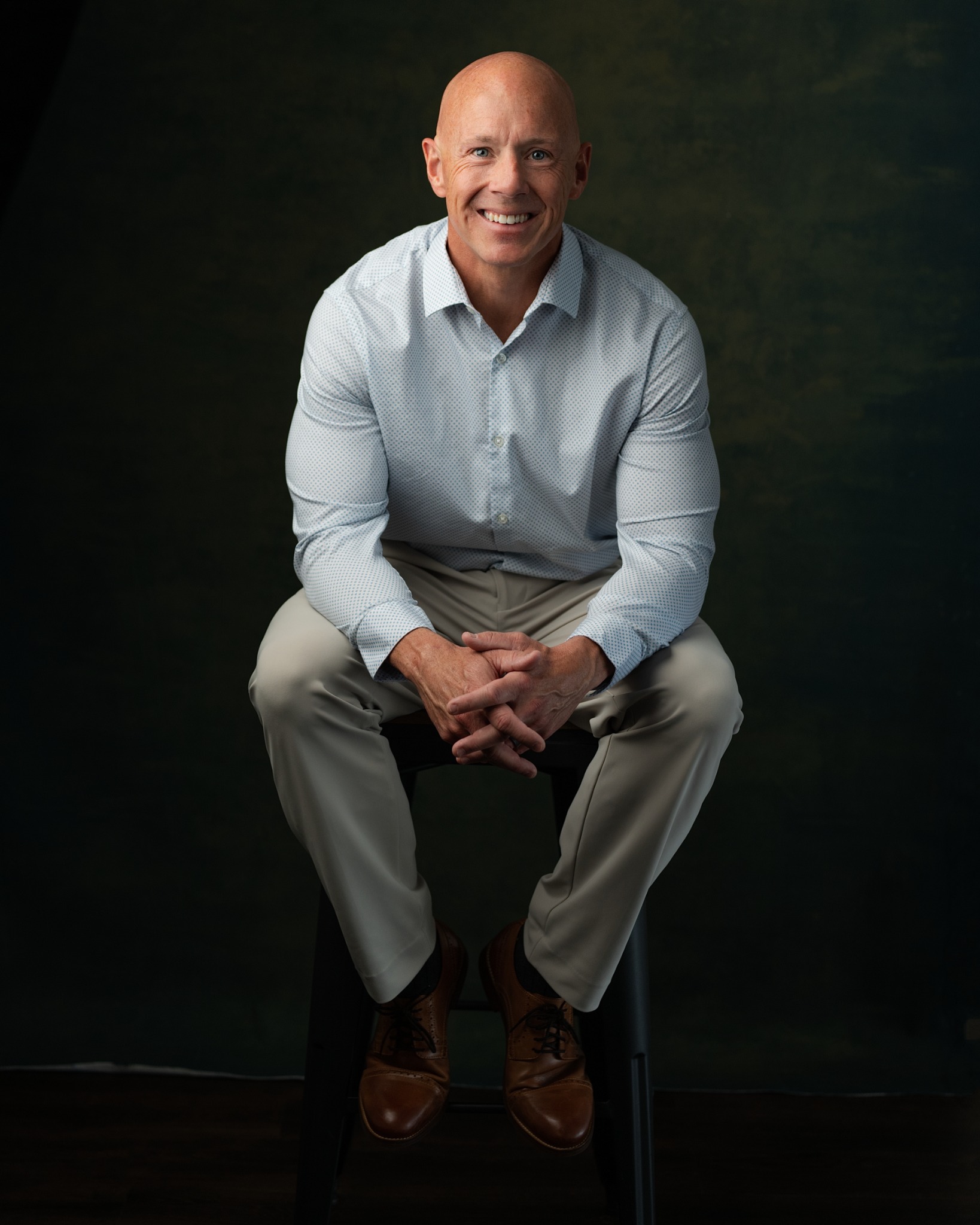 Brian Flanigan seated and smiling